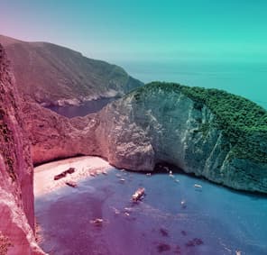 Aerial view of holidaymakers visiting a shipwreck in a sandy cove